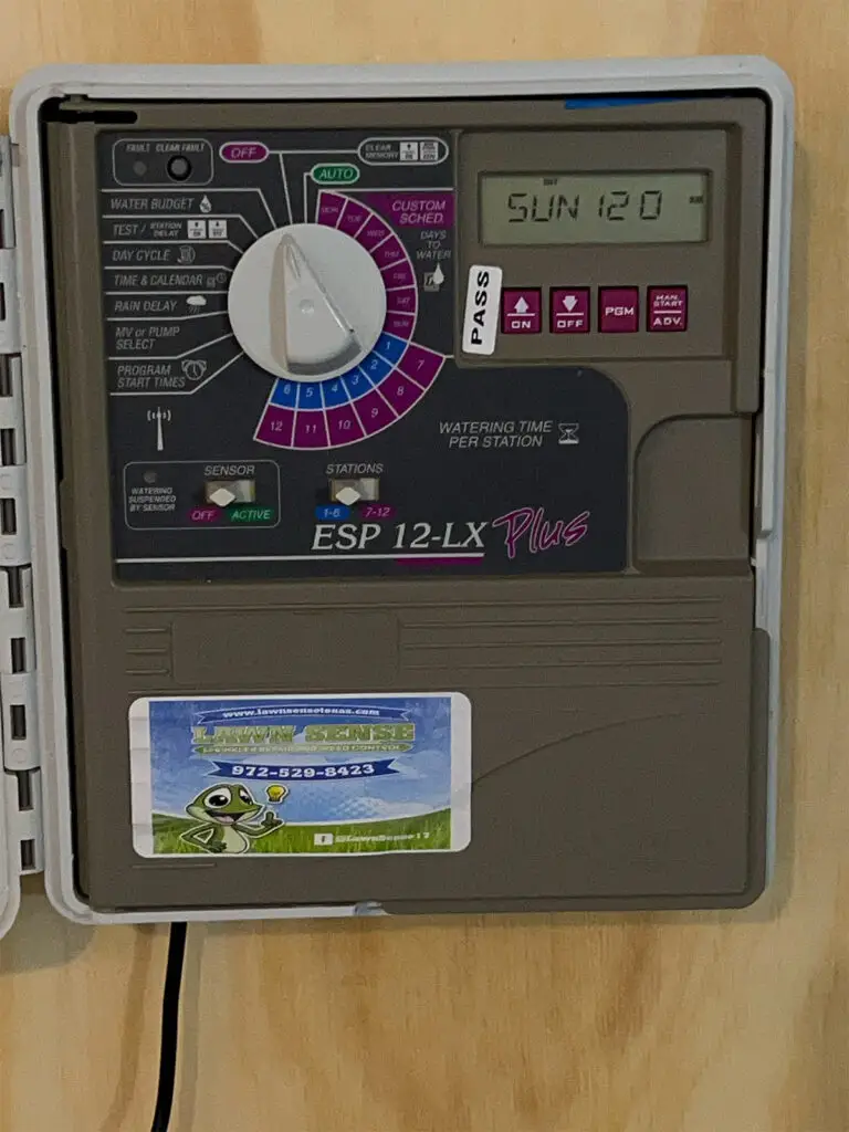 A RainBird LX Plu -Controller with the front open to see inside.