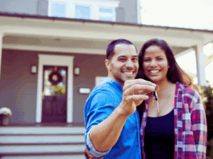 New homeowners outside new home